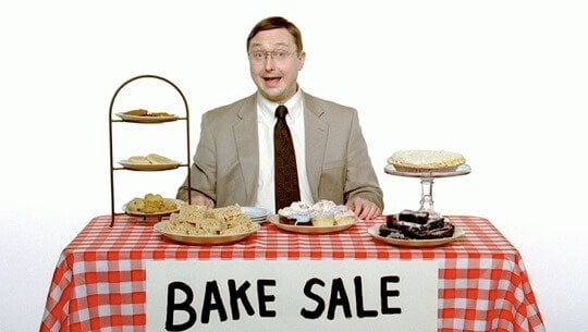 a man sitting at a table with food on it