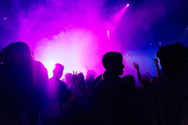party with people under smoke and purple light