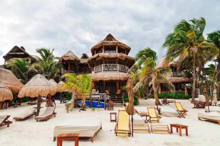a beach with chairs and umbrellas
